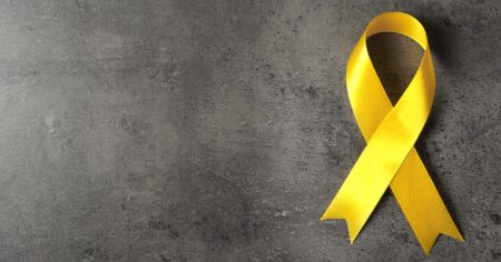 https://www.shutterstock.com/image-photo/yellow-awareness-ribbon-on-grey-textured-431657347